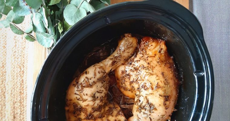 TOp view of Rosemary chicken quarters in crockpot insert