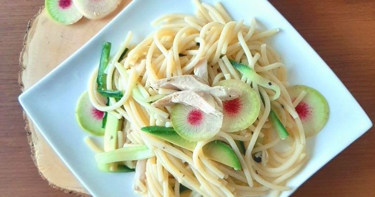 Green pasta with shredded chicken decorated with watermelon radish top view