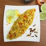 Top view of yellow rice with lime and spices