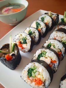 Chicken kimbap rolls with kelp soup in the background