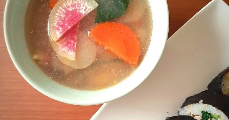 Watermelon sunchoke soup with spinach and carrots top view