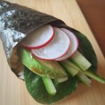 Vegan hand roll on a bamboo board