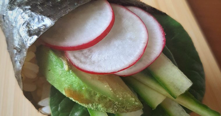 Vegan hand roll on a bamboo board
