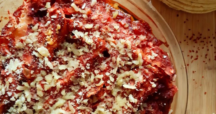 Chicken enchilada with beets and tomato sauce top view