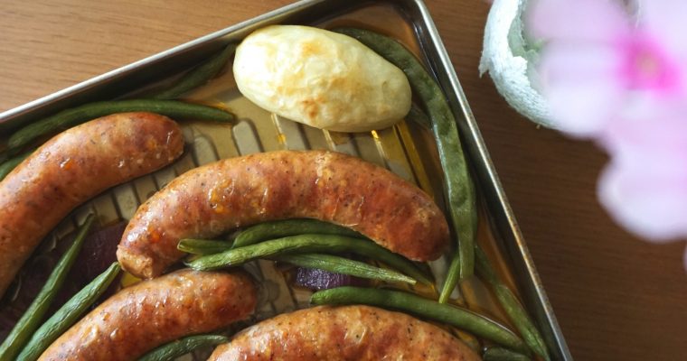 Sausage Sheet-pan Dinner top view with blurred flowers