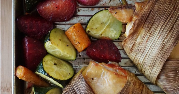 Corn husk-wrapped chicken thighs with roasted veggies