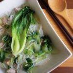 Tender chicken noodle soup close up with chopsticks and spoon