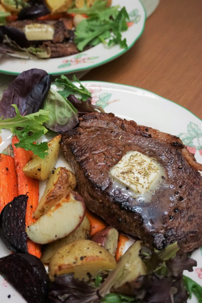 Sirloin steak with roasted veggies in a plate