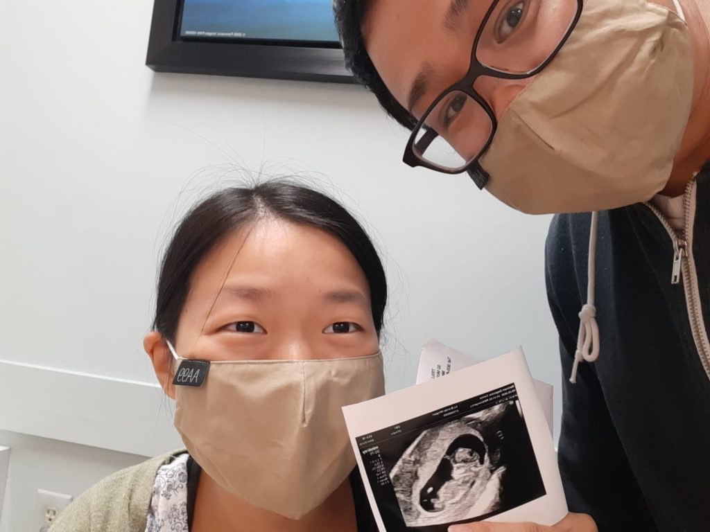 Me and my hubby holding our first ultrasound printout