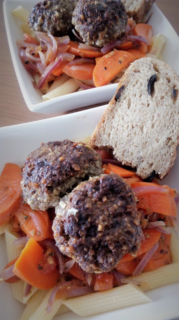 Giant Italian meatballs served on pasta with GF sourdough
